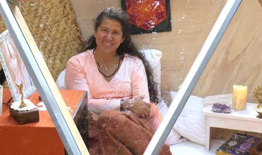 Mataji Shaktiananda smiling, dressed in white, in a bright space