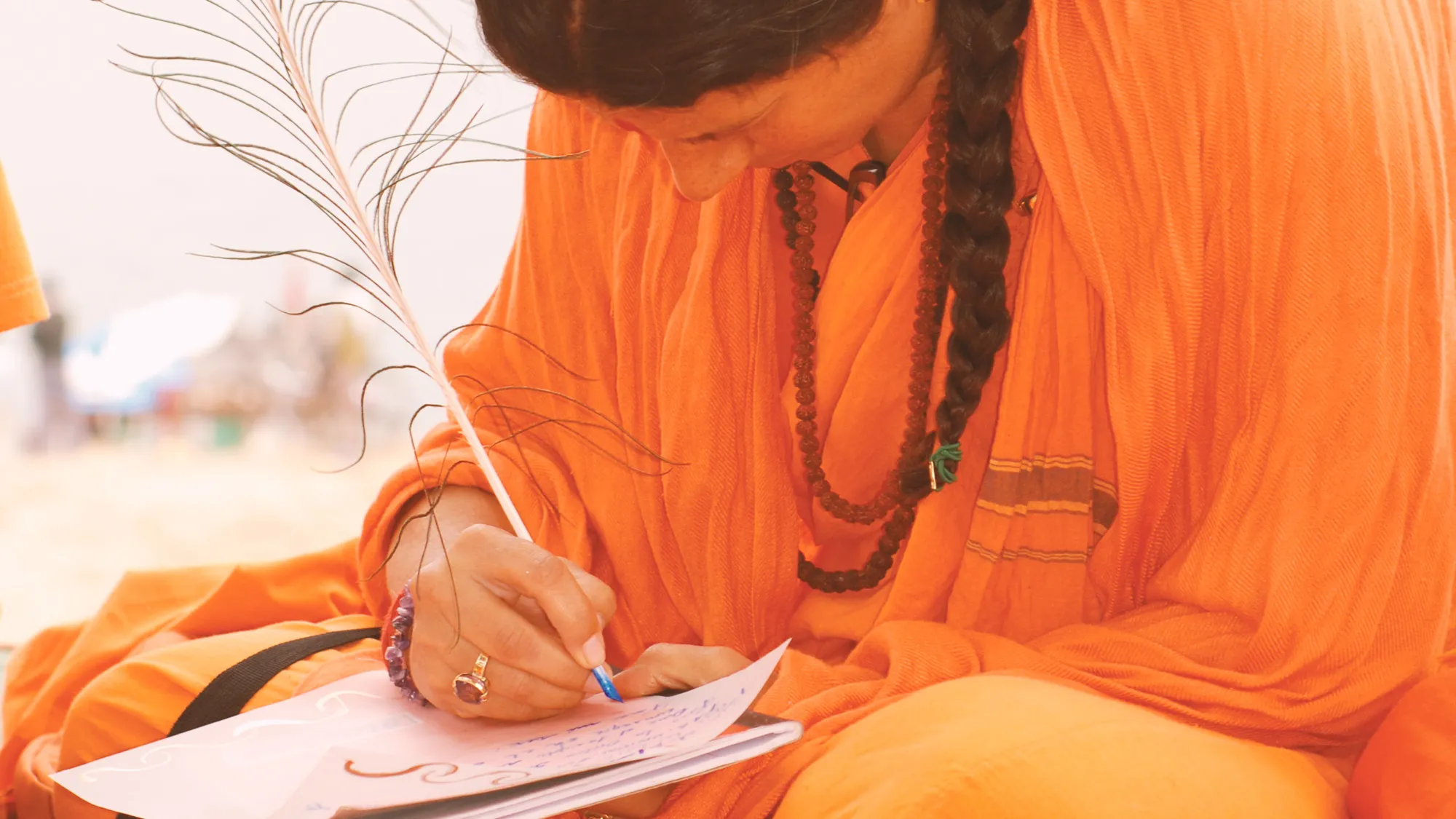 Mataji Shaktiananda in orange, writing